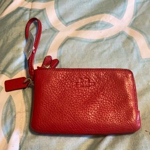 Persimmon colored Coach wristlet